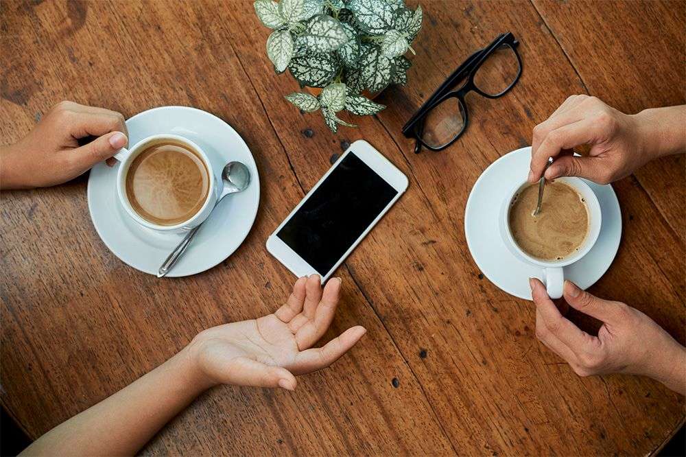 2-people-having-a-meeting-over-coffee.jpg