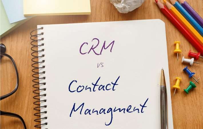 CRM vs Contact Management handwritten in pen on a note book to set the scene for the article.