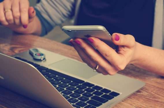 Lady syncing contacts over multiple devices.
